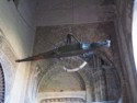 A wooden alligator hangs in the entrance to the cathedral courtyard